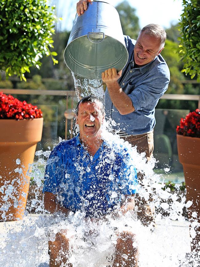 Neale Daniher does the ice bucket challenge with the help of friend and footy legend Tim Watson to promote the Big Freeze At The G, which has significantly raised the profile of efforts to find a cure. Picture: Tim Carrafa