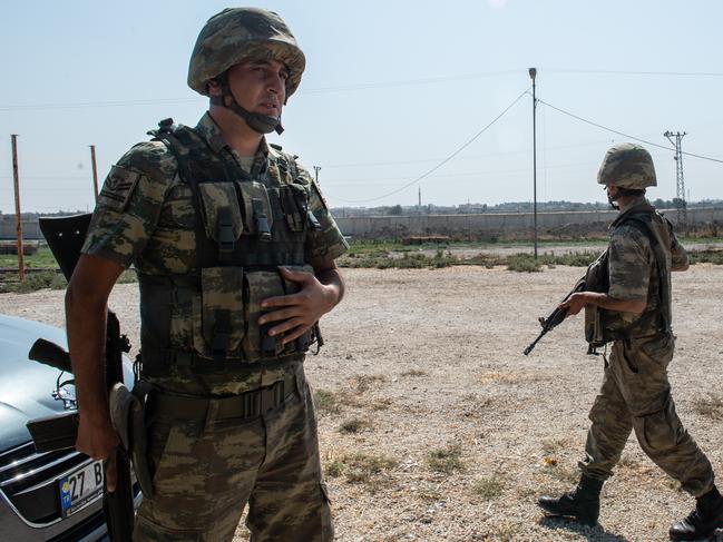 Turkish soldiers stand guarded in the Turkish side of the border between Turkey and Syria. Picture: Getty