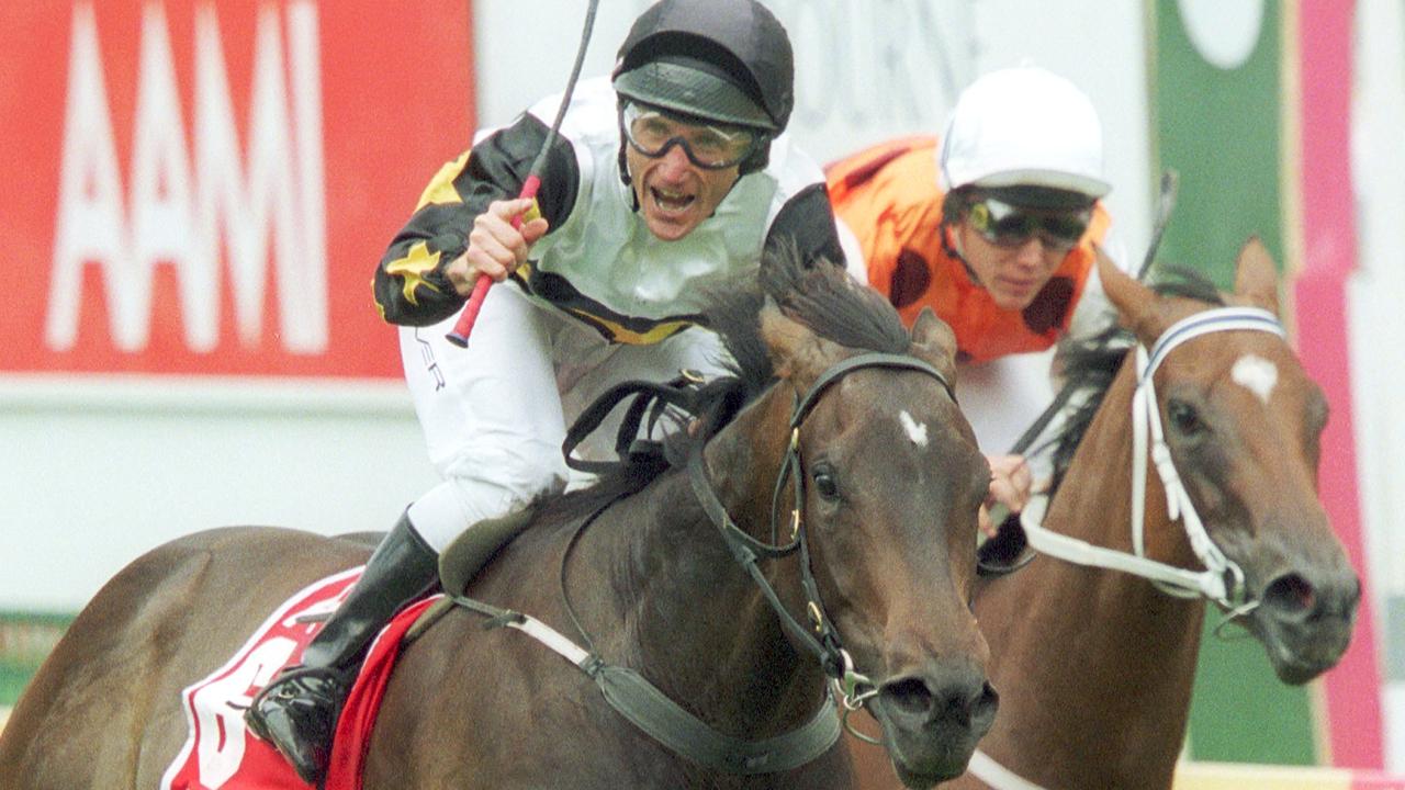 Damien Oliver salutes the crowd after winning the Blue Diamond on Alinghi.