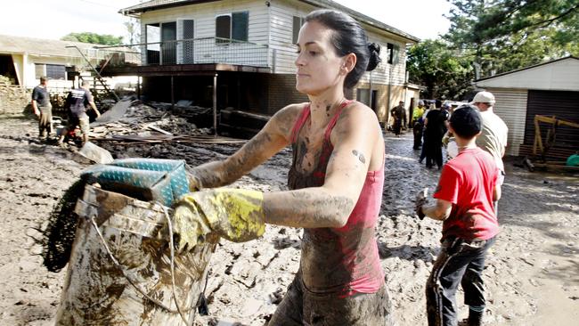 Gold Coast resident Aleaysha Burney helping with the flood clean up at Brisbane Tce, Goodna on Saturday. Picture: Sarah Harvey