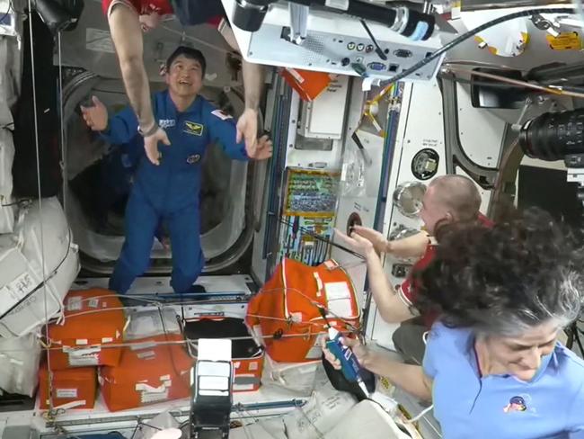 JAXA astronaut Takuya Onishi (C) greeting members of the International Space Station crew shortly after docking at the ISS. Picture: NASA / AFP