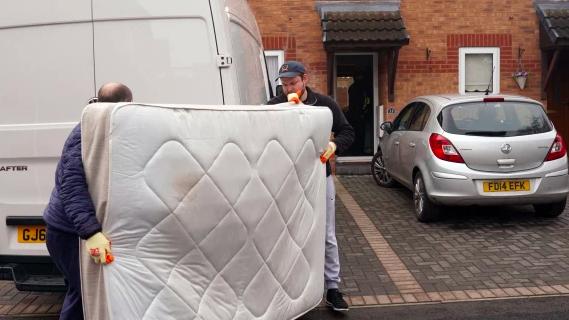 Removal people arrived at the house to take a bed away. Picture: Roland Leon