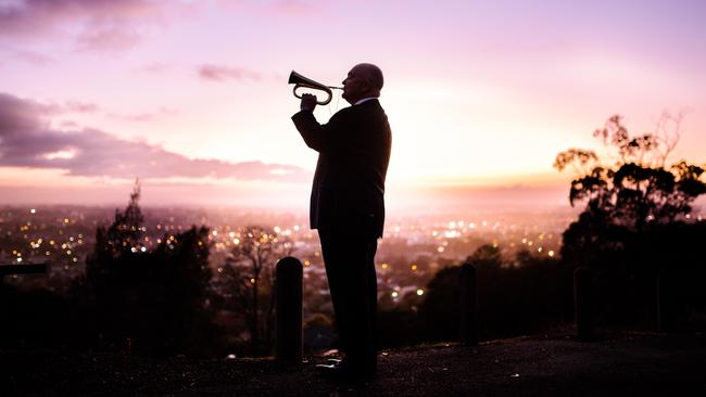 James Morrison plays the bugle at dawn overlooking the city ahead of the Anzac Day in Mount Gambier, South Australia, Friday, April 24, 2020. Picture: Morgan Sette/The Australian