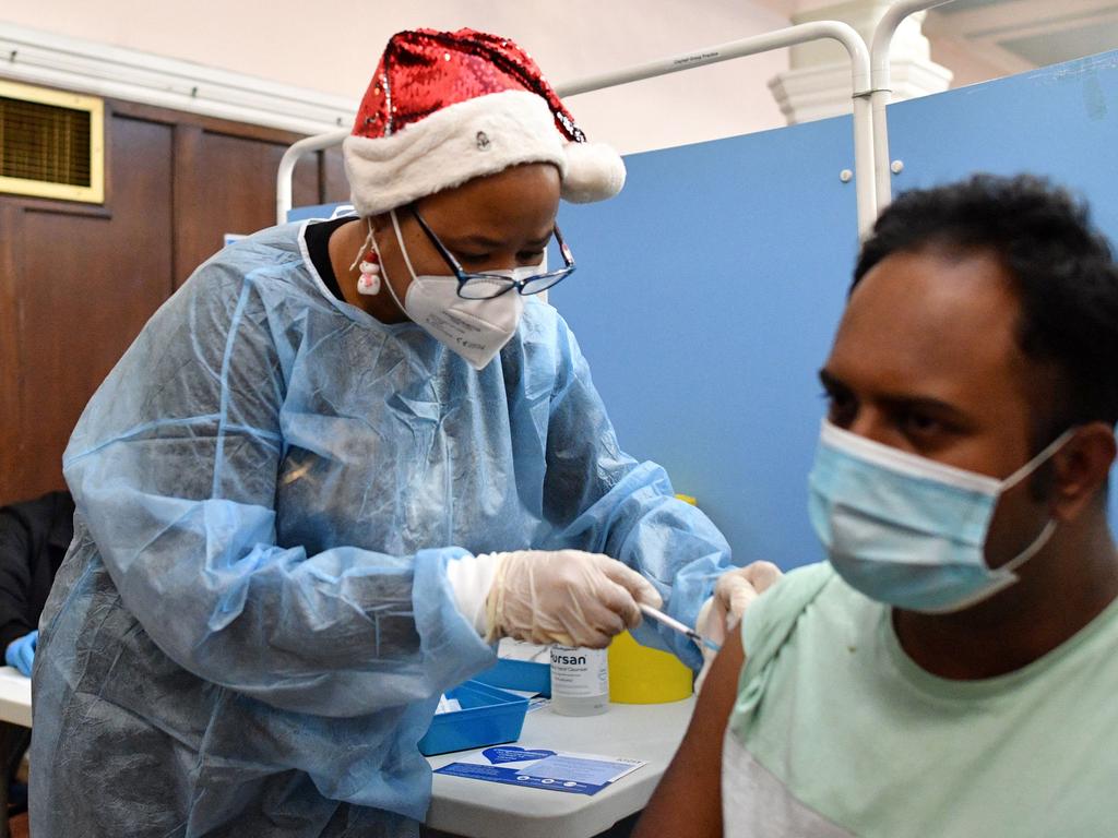 An NHS health worker administers a dose of the Covid-19 vaccine at a London clinic. Picture: AFP