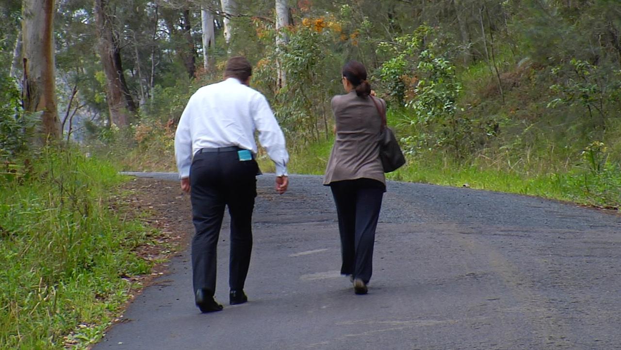 Detectives walk up the road where Mr Walker’s body was discovered by a passing motorist the day after he was killed. Picture: David Cleverly.