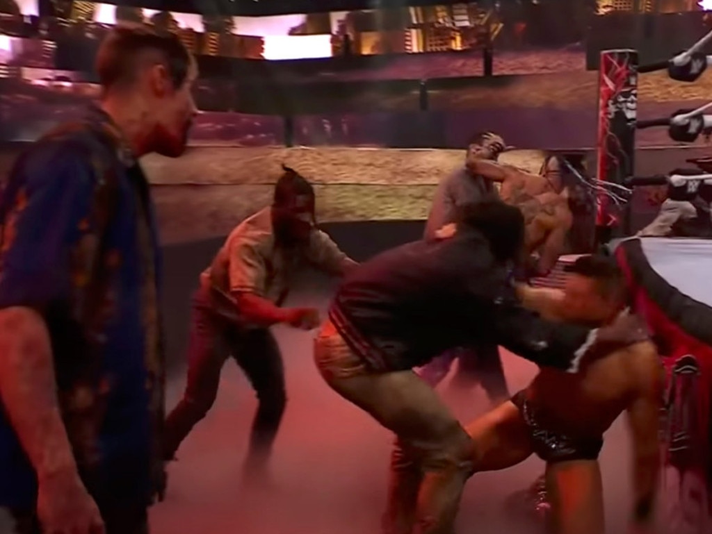 A group of zombies attack The Miz and Damien Priest.