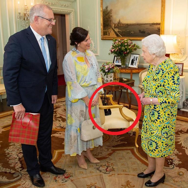 Queen Elizabeth II meets Scott and Jenny Morrison and leaves her bag on the chair. Picture: Dominic Lipinski/AFP