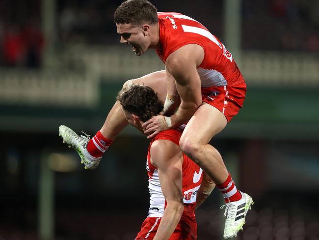 Tom Papley leaps over Will Hayward after he kicked a big goal on the three-quarter time siren. Picture: Phil Hillyard