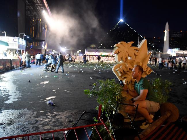 A person takes cover at the Route 91 Harvest country music festival. Picture: David Becker/Getty