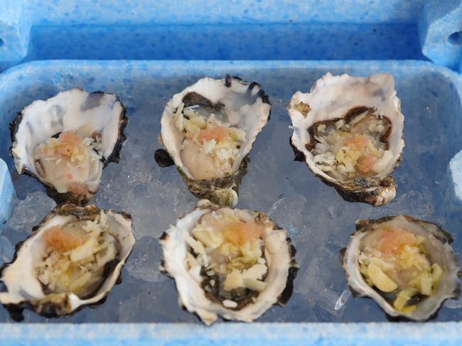 Oysters are served in an Esky and are sprinkled in finger lime and shaved macadamia. Picture Glenn Hampson