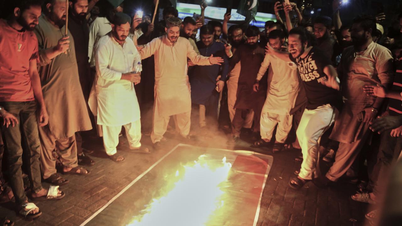 Pakistani protesters burn an Indian flag after the strikes. Picture: Pervez Masih/AP