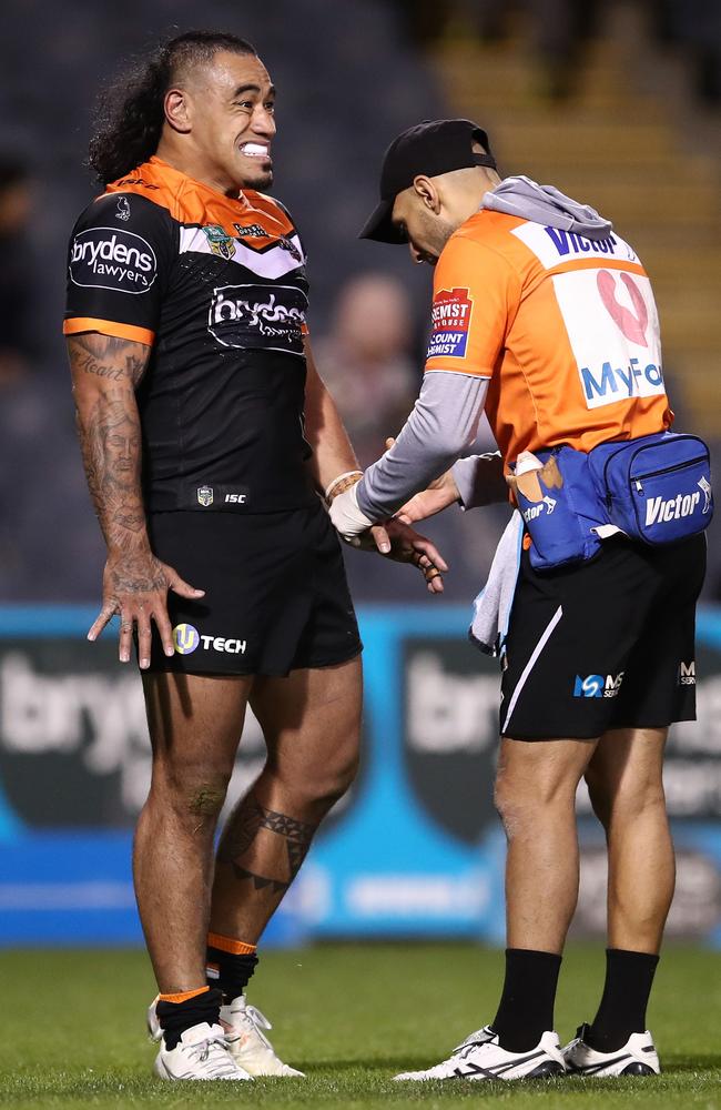 Mahe Fonua receives attention from a trainer after suffering a broken arm.