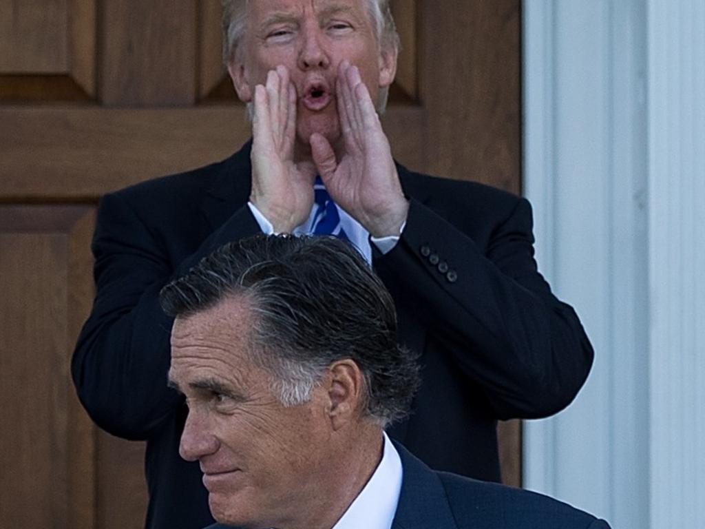 Donald Trump calls out to the press as Mitt Romney leaves after their meeting. Picture: Getty