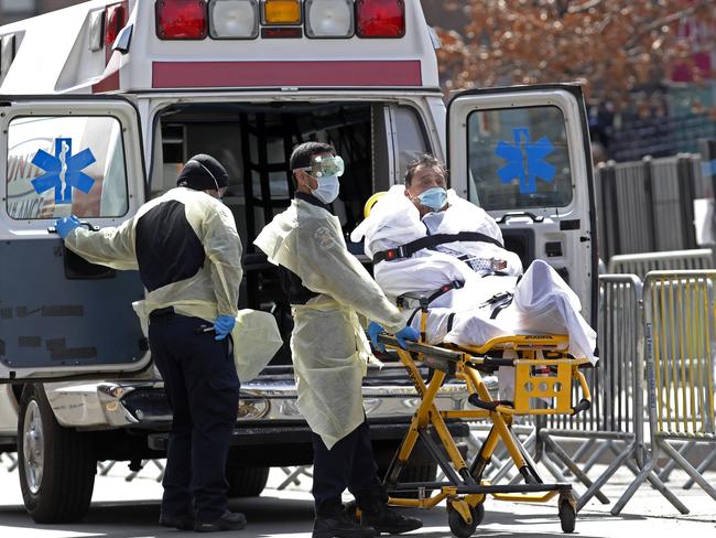 A patient is wheeled out of Elmhurst Hospital Center to a waiting ambulance in the Queens borough of New York. Picture: AP