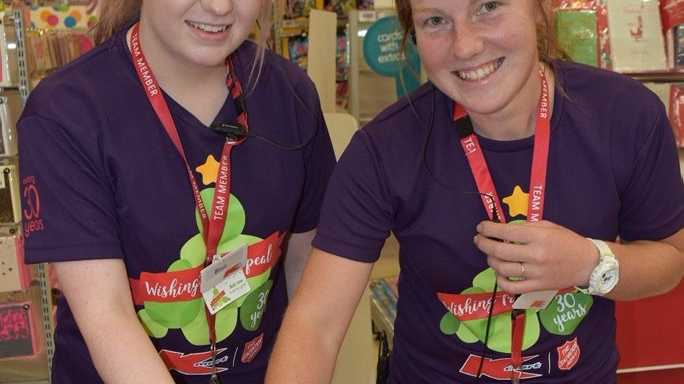 Kmart Wishing Tree Champions Blair Gordon and Hannah Willis cut the cake to launch Kmart Grand Central's Appeal