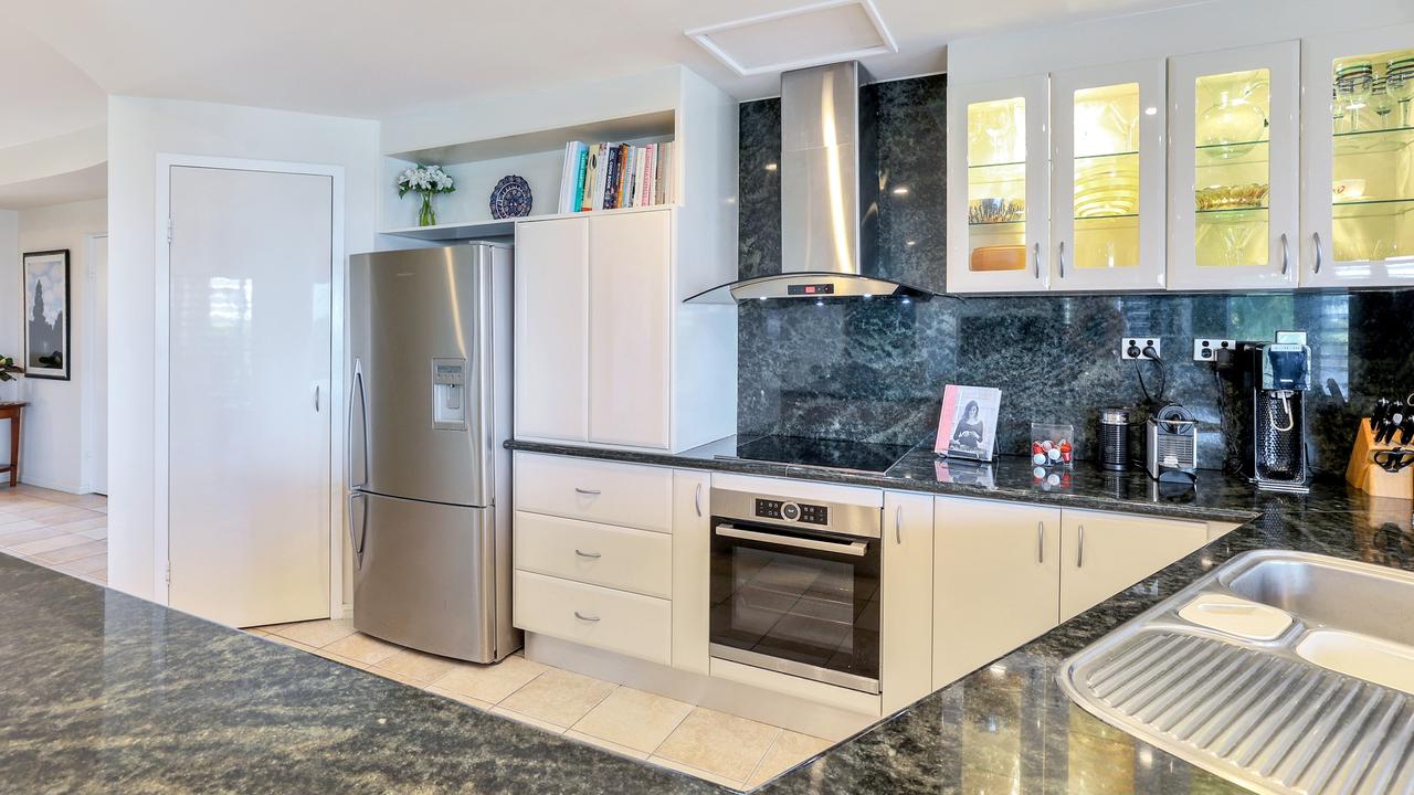 The kitchen has stone benchtops and splashback. Picture: Supplied