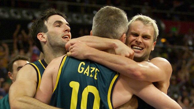 Andrew Gaze is hugged by teammates Sam Mackinnon (L) and Shane Heal during the Sydney Games. Picture: David Kapernick