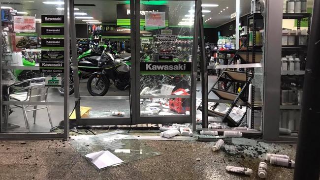 The damage left behind at Mackay Kawasaki after thieves used a stolen red LandCruiser to ram and raid the store and steal a motorbike.