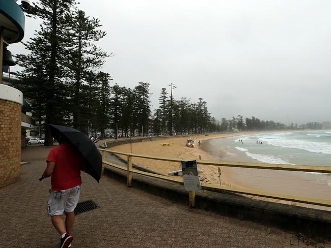 Dark clouds and rain at Manly Beach. Picture: Tim Hunter