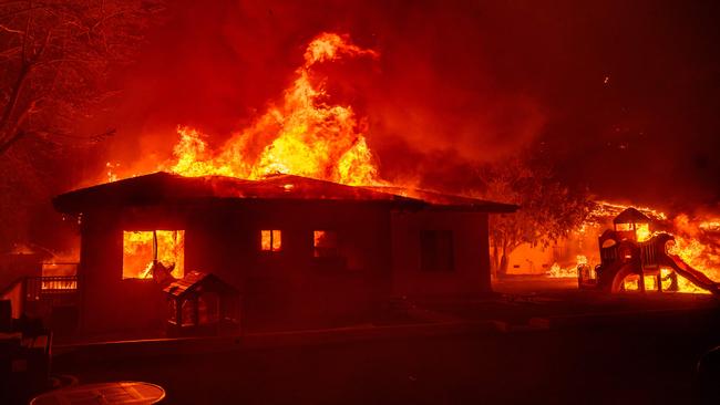 A home is engulfed in flames in Pasadena, California. Picture: AFP