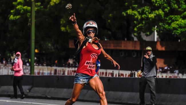 Caterina Ciarcelluti clashes with police during a march against Venezuelan President Nicolas Maduro on May 1, 2017. Picture: AFP
