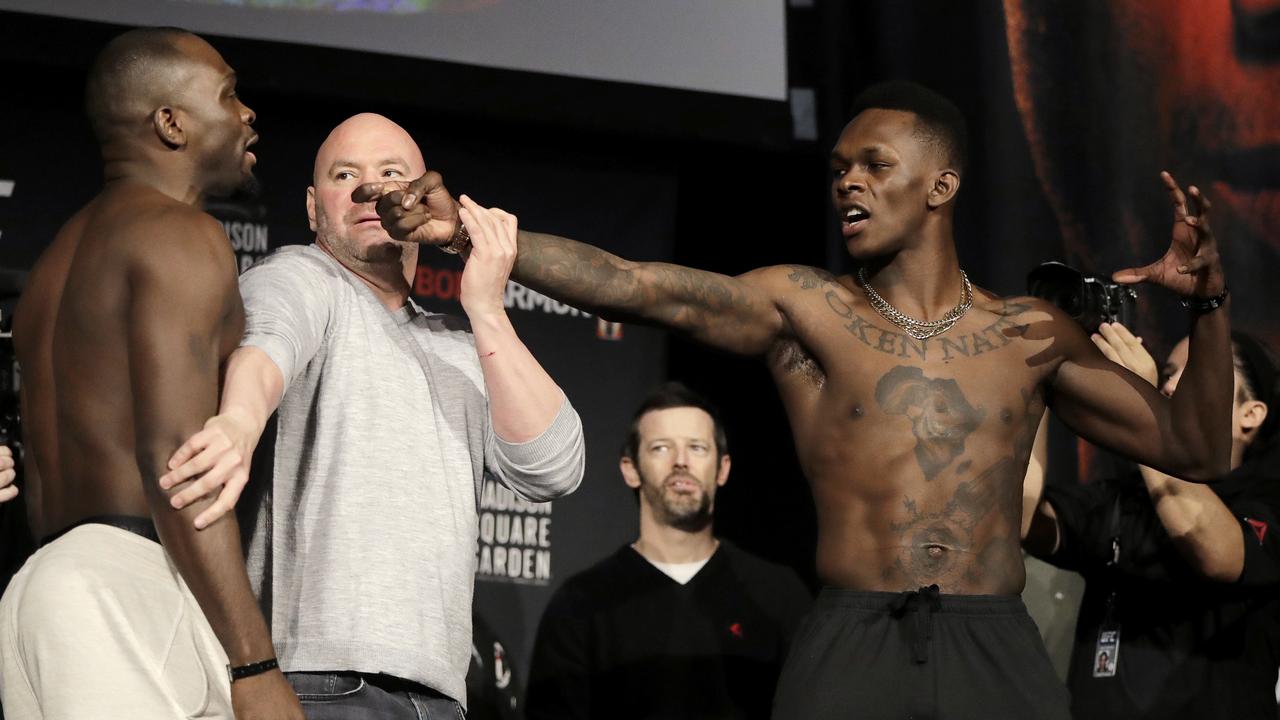 UFC President Dana White, centre, gets between Israel Adesanya, right, and Derek Brunson during a face-off.