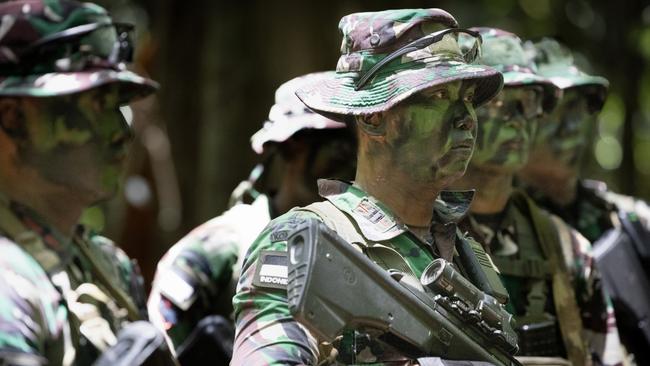 Indonesian Army soldiers (Tentara Nasional Indonesia) listening to their chain of command after a section attack at the Junior Officer Combat Instructor Training Course held in Tully, November 2024. PHOTO: CPL Luke Bellman