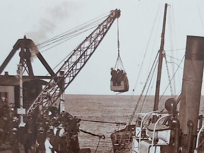 Passengers are lifted using a basket while landing at the Coffs Harbour Jetty circa 1910.