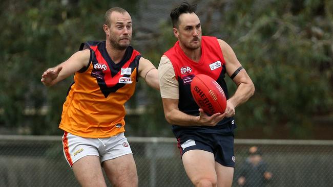 Tullamarine’s Brad Allen is put under pressure by East Keilor’s Ash Arrowsmith. Picture: Hamish Blair