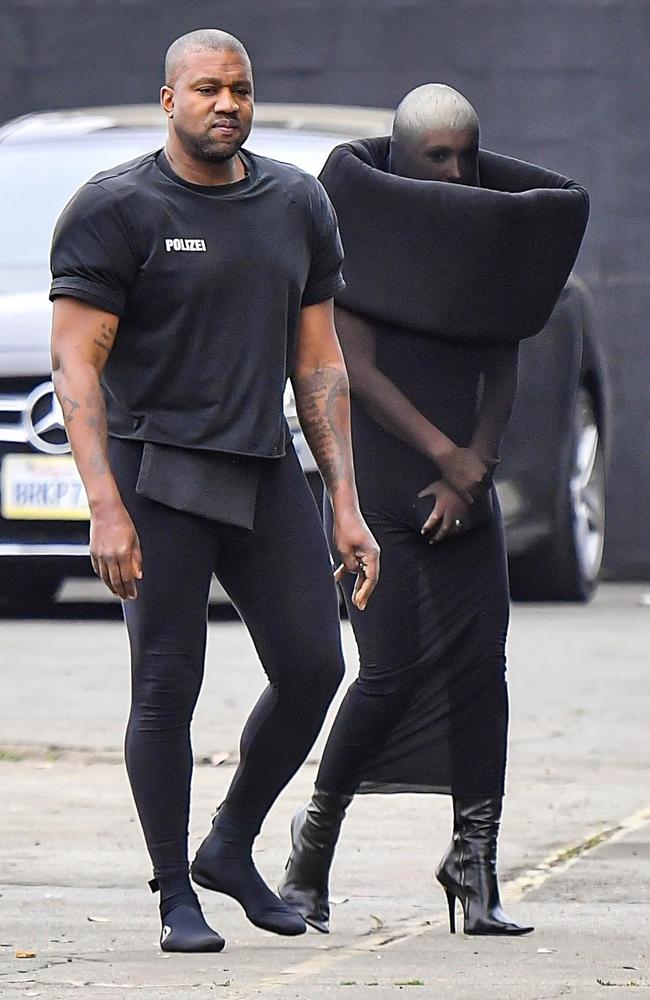June 4, 2023: In what was one of the most impractical outfits seen so far, Censori wore this all black body suit that restricted any normal hand movement. Kanye completed the bizarre ensemble by wearing shoulder pads. Picture: CelebCandidly / BACKGRID
