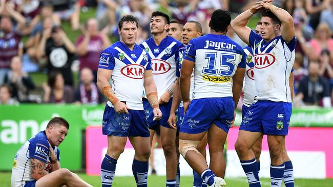 Bulldogs players look on after conceding a try to the Sea Eagles.