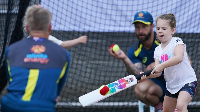 David Warner, left, and Matthew Wade play in the nets with Warner’s daughter Ivy Mae