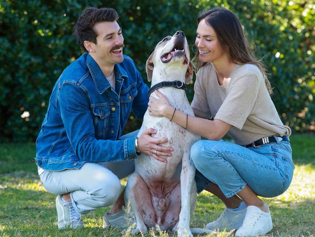 The fun-loving couple with their three legged dog Buster. Picture: Justin Lloyd