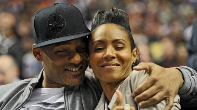 Smith and his wife Jada Pinkett Smith share a moment on the sideline during the game between the Philadelphia 76ers and Miami Heat in 2012. Picture: Drew Hallowell/Getty Images