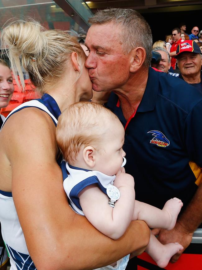 Greg Phillips gives his daughter Erin a kiss after she led the Crows to the inaugural AFLW premiership in 2017. Picture: Jason O'Brien/Getty Images