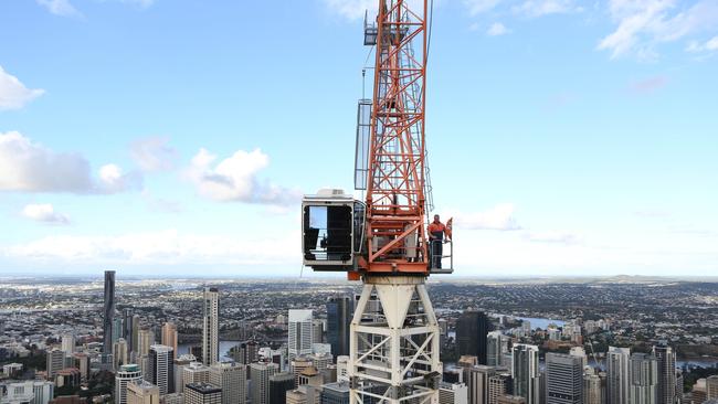 A crane operates above the Melbourne skyline.