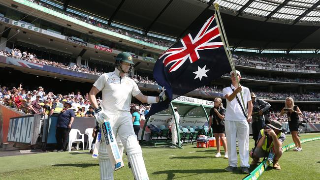 Steve Smith touches the Australian flag as he heads out to bat. Picture: Michael Klein