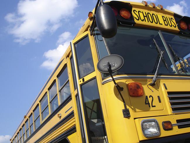 School Bus Number 42Schoolboy on mobile phone, and school bus generic Thinkstock