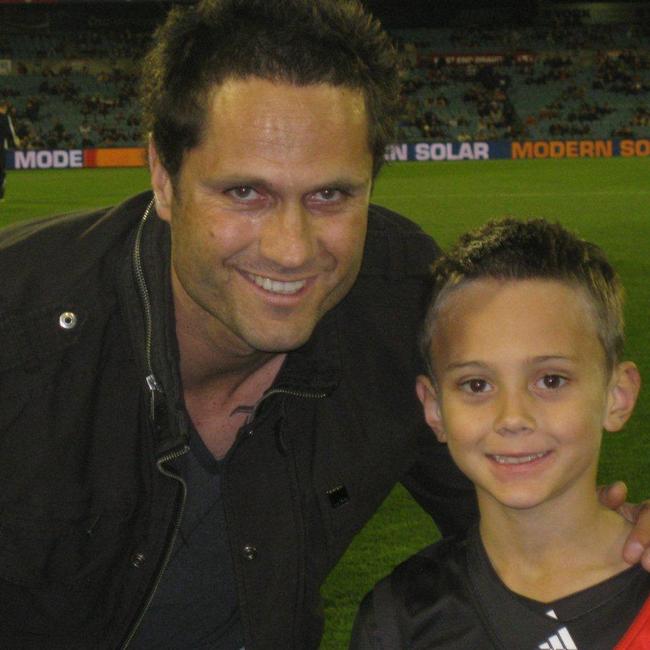 Gavin Wanganeen with Tex in 2011, when he was a mascot for an Essendon game in Adelaide.