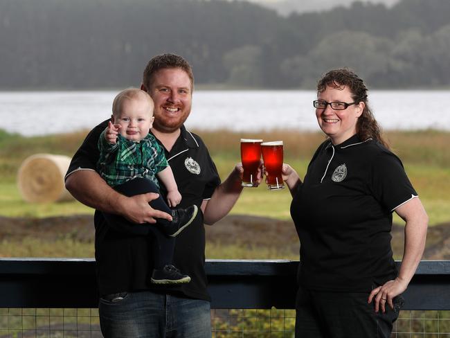 Smiling Samoyed Brewery owners and brewers Kate Henning and her husband Simon Dunstone with their son Alvin at their Myponga Micro Brewery with the Myponga Reservoir in the background. Picture: Dylan Coker