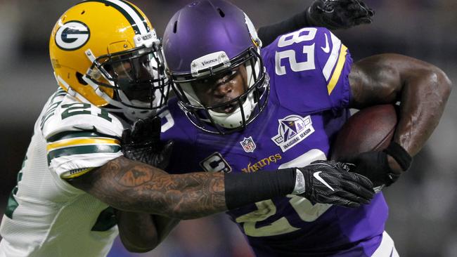 Minnesota Vikings running back Adrian Peterson (28) tries to break a tackle.