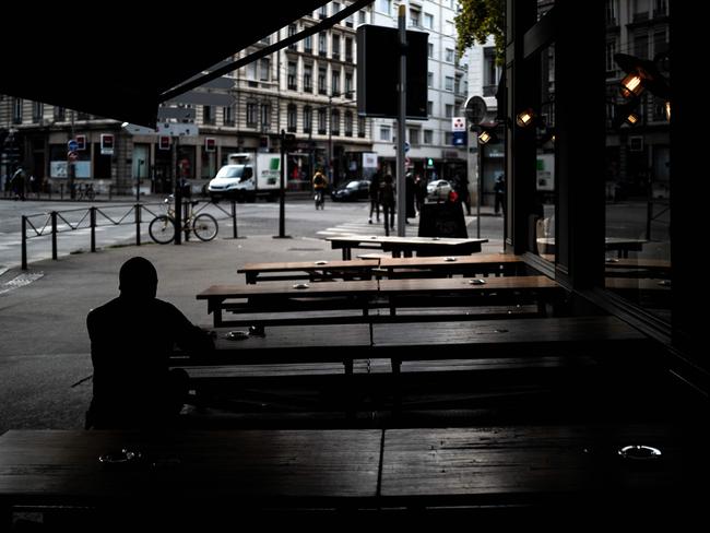 A customer sits at a cafe in Lyon France after the city was placed on maximum coronavirus alert. Picture: AFP