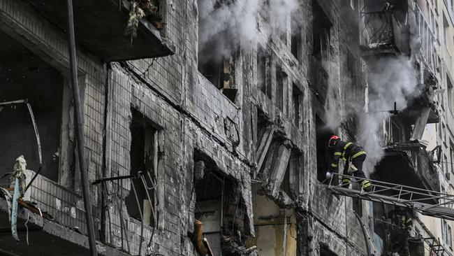 A firefighter enters a building after it was shelled in the northwestern Obolon district of Kyiv. Picture: AFP