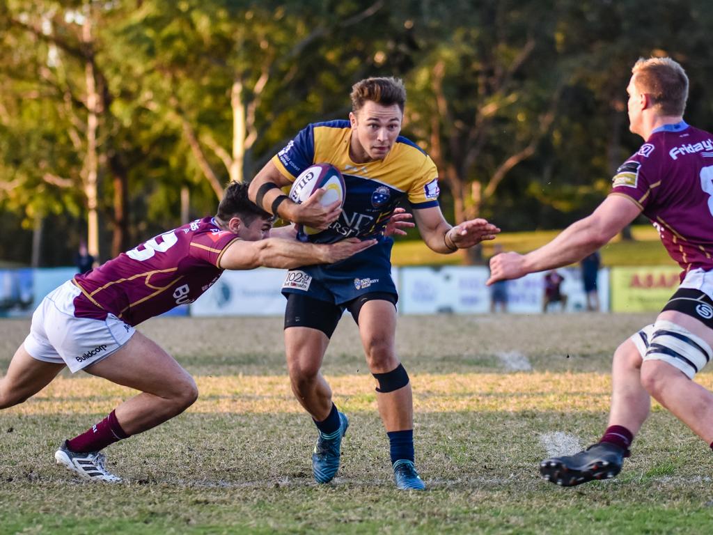 Hayden Sargeant runs the ball for Bond University against University of Queensland. Picture: Stephen Tremain