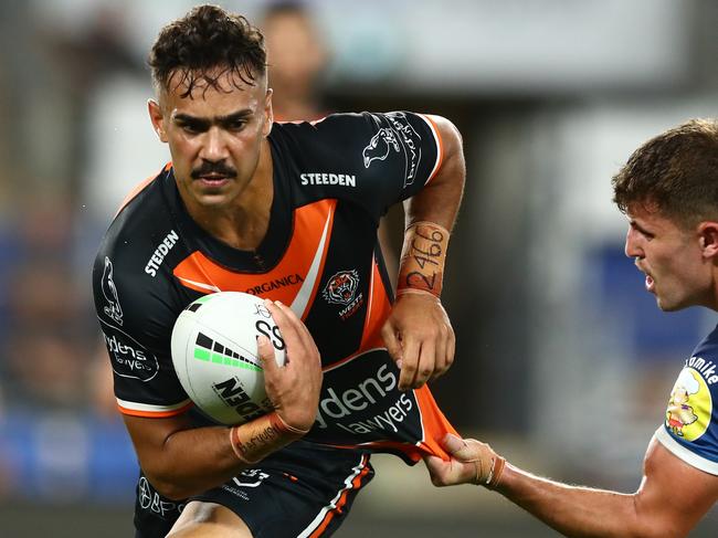 GOLD COAST, AUSTRALIA - MARCH 31: Daine Laurie of the Tigers runs the ball during the round four NRL match between the Gold Coast Titans and the Wests Tigers at Cbus Super Stadium, on March 31, 2022, in Gold Coast, Australia. (Photo by Chris Hyde/Getty Images)