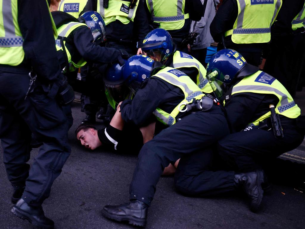 Police officers detain a protestor during the 'Enough is Enough' demonstration in central London on Wednesday (local time). Picture: AFP