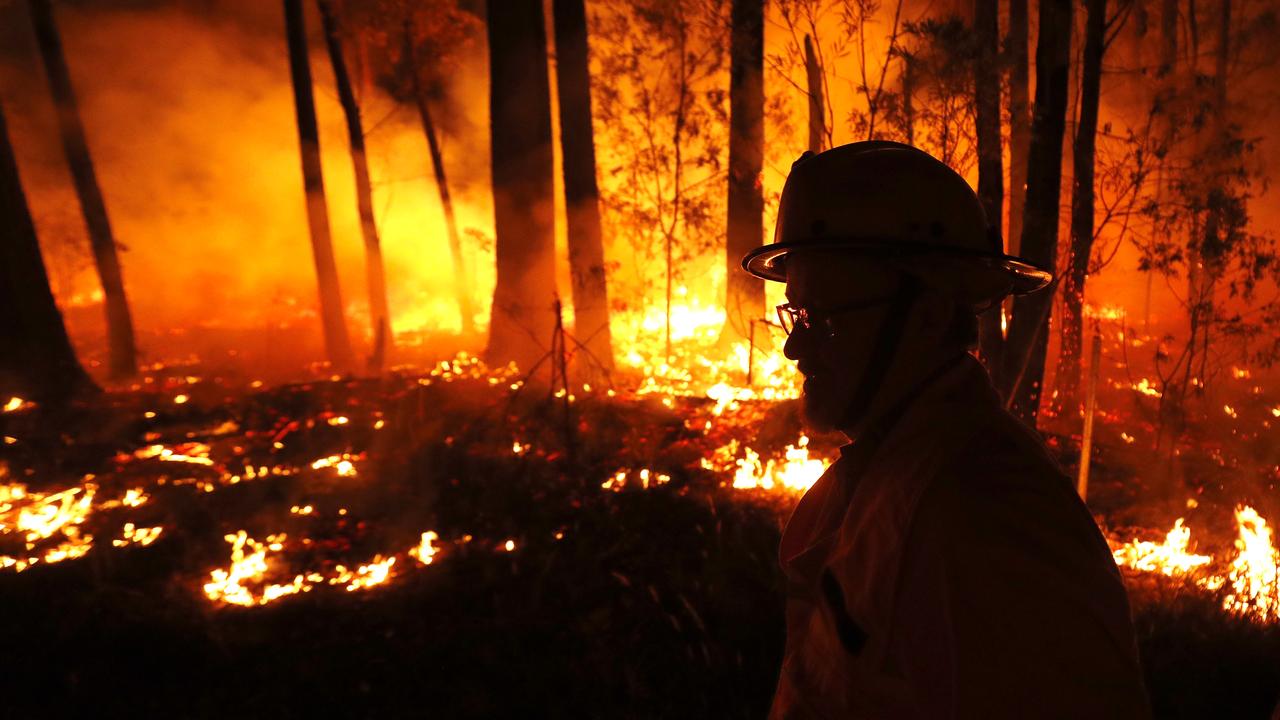 A firefighter monitors a fire in north-east Victoria on Thursday. Picture: Getty Images