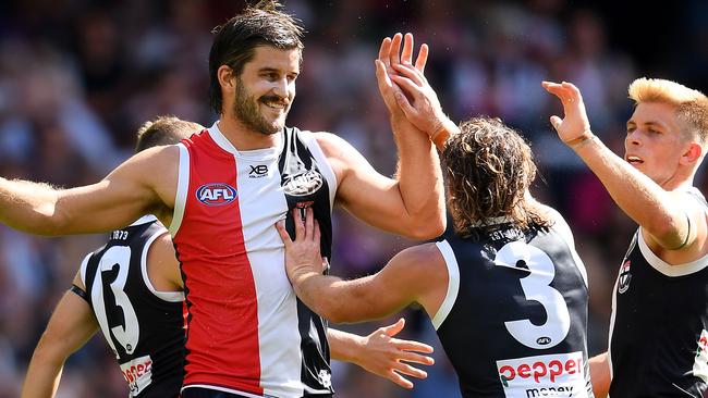 MELBOURNE, AUSTRALIA - MARCH 24: Josh Bruce of the Saints is congratulated by team mates after kicking a goal during the round one AFL match between the St Kilda Saints and the Gold Coast Suns at Marvel Stadium on March 24, 2019 in Melbourne, Australia. (Photo by Quinn Rooney/Getty Images)