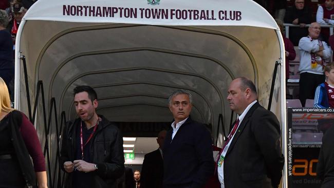 Manchester United's Portuguese manager Jose Mourinho (C) waits.