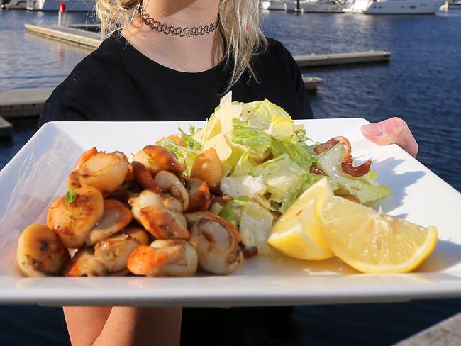 Waitress Ruby Keady with Fish Frenzy's pan-seared fresh Tasmanian scallops with salad.